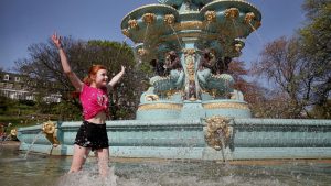 Zoe Beatson, 11, cools off in the Ross Fountain in Edinburgh's Princes Street Gardens