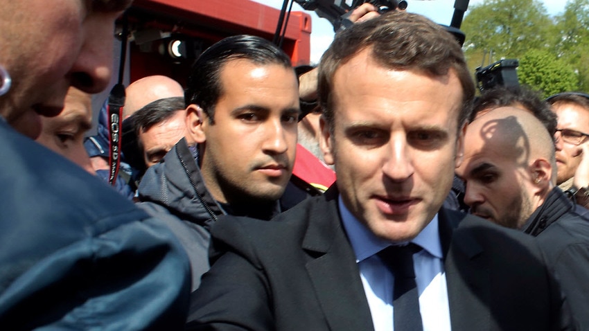 File image of French president Emmanuel Macron, right, flanked by his bodyguard, Alexandre Benalla (AAP)