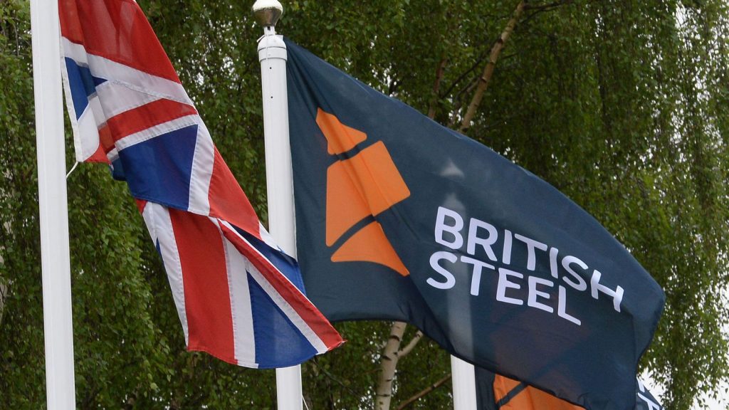 British Steel logo displayed on flags at the entrance to the steelworks plant in Scunthorpe