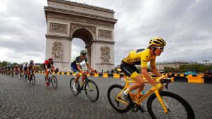 FILE - In this July 29, 2018 file photo, Tour de France winner Britain's Geraint Thomas, wearing the overall leader's yellow jersey, passes the Arc de Triomphe during the twenty-first stage of the Tour de France cycling race over 116 kilometers (72.1 miles) with start in Houilles and finish on Champs-Elysees avenue in Paris, France. Chris Froome's absence, coupled with the withdrawal of last year's runner-up Tom Dumoulin, has reshuffled the game and produced a long list of top contenders.